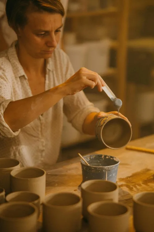 Potter shaping clay on a wheel
