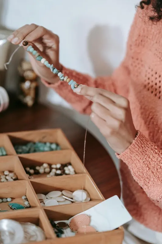 Hands crafting a ring at a jeweller's workbench