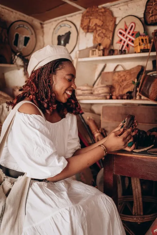 Artisan stitching a leather bag